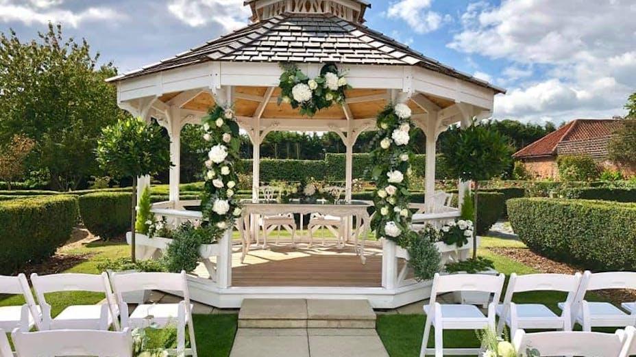 Decorated gazebo backyard wedding ceremony