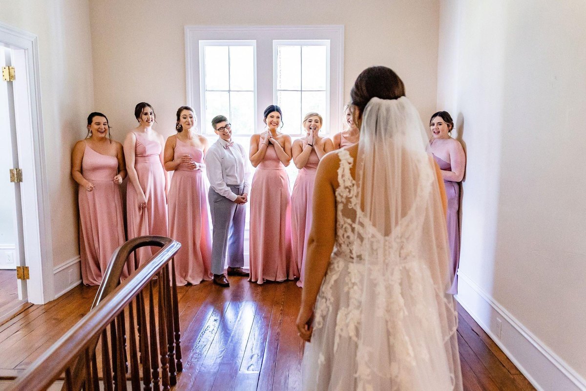 Bridesmaids looking at bride