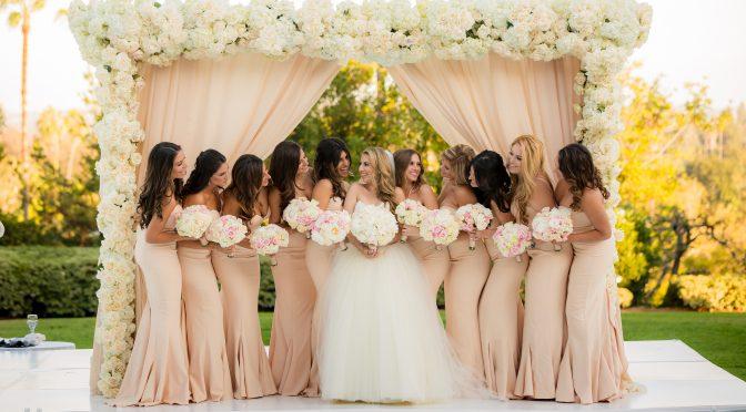 Bridesmaids under wedding arch