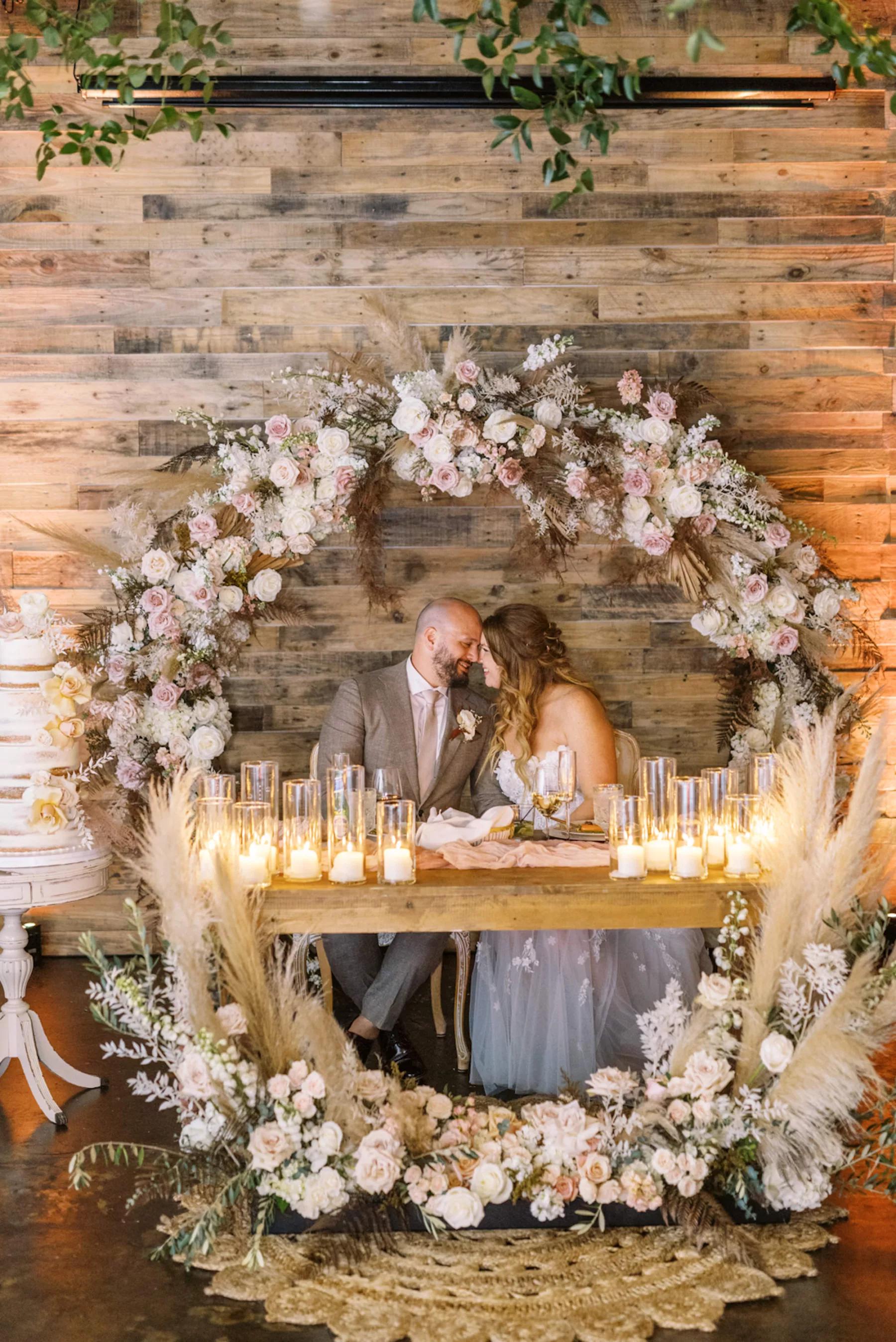 Sweetheart table glowing with wedding candles