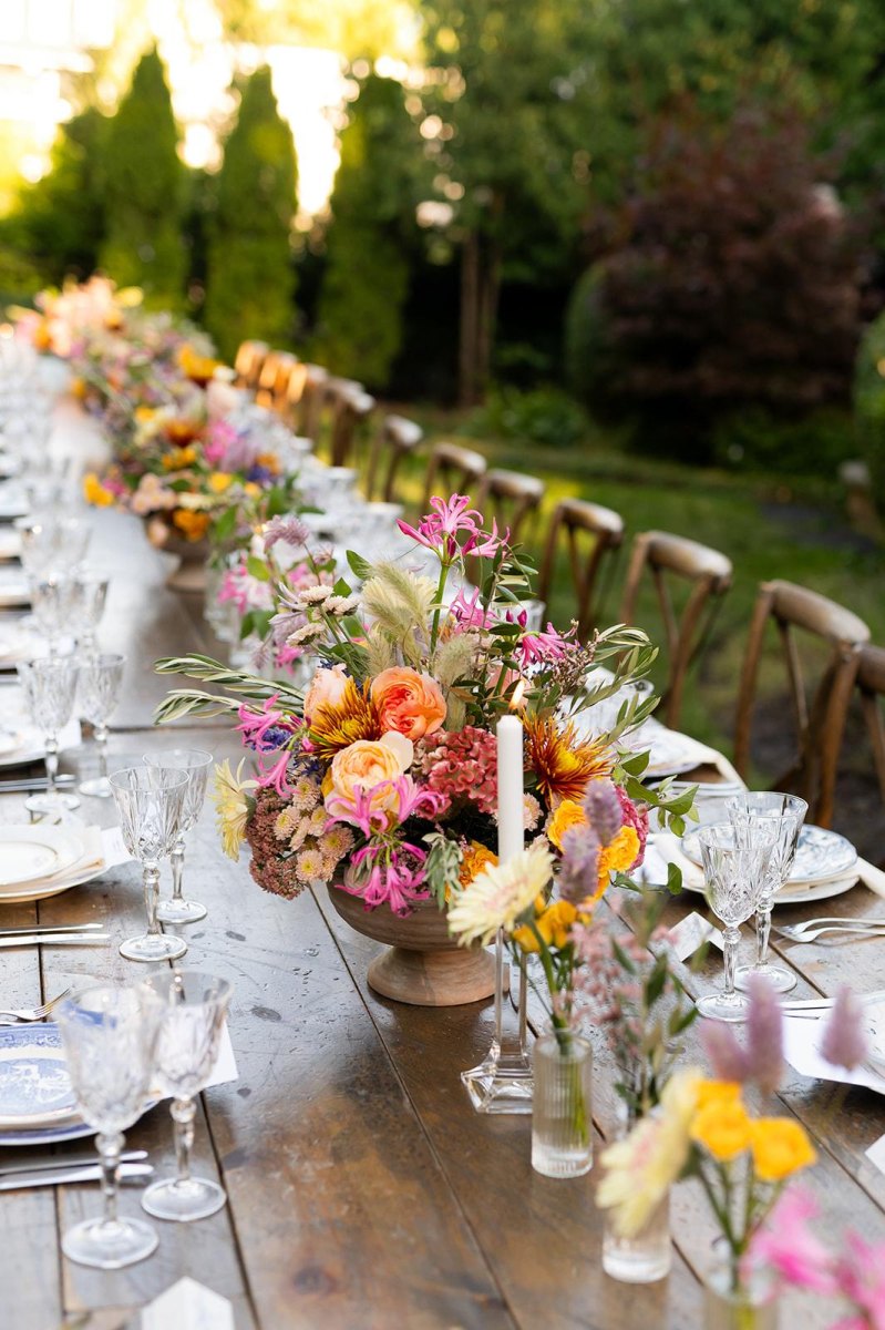 Colorful floral centerpiece on backyard wedding table