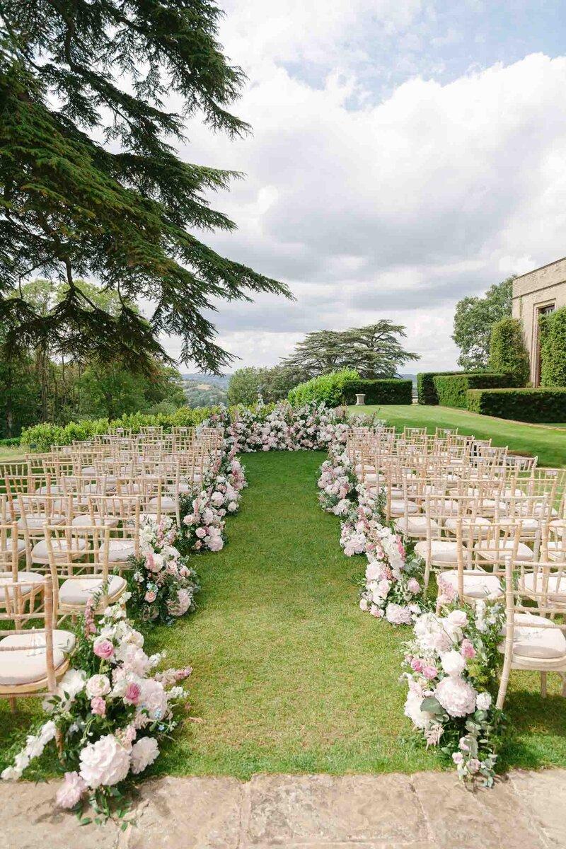 Flower decorated garden wedding aisle
