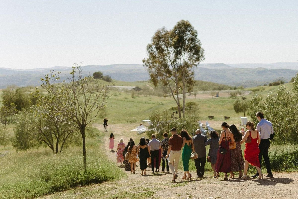 Wedding guests walking on outdoor terrain