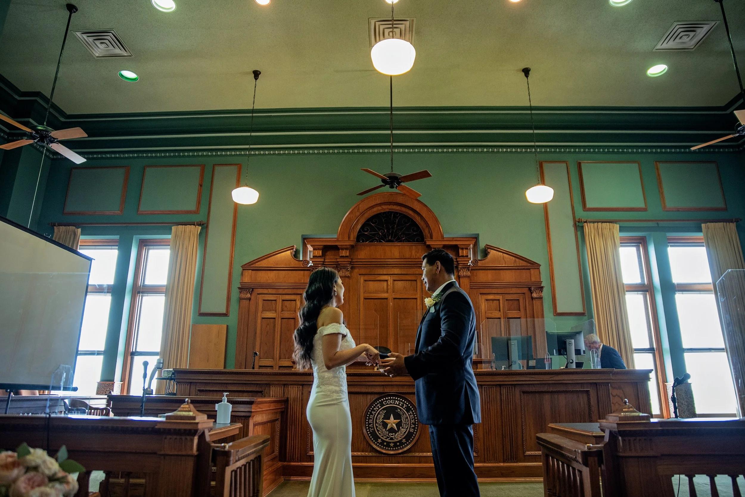 Couple exchanging vows inside courthouse