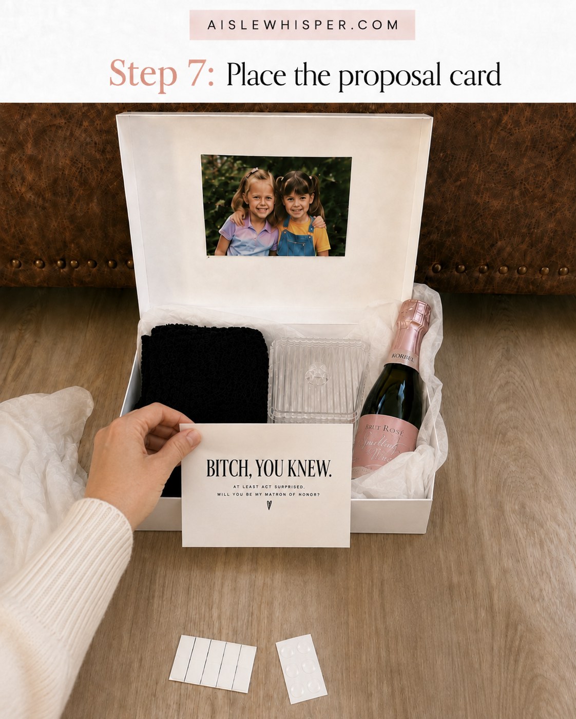 Placing the matron of honor proposal card on top inside the finished gift box