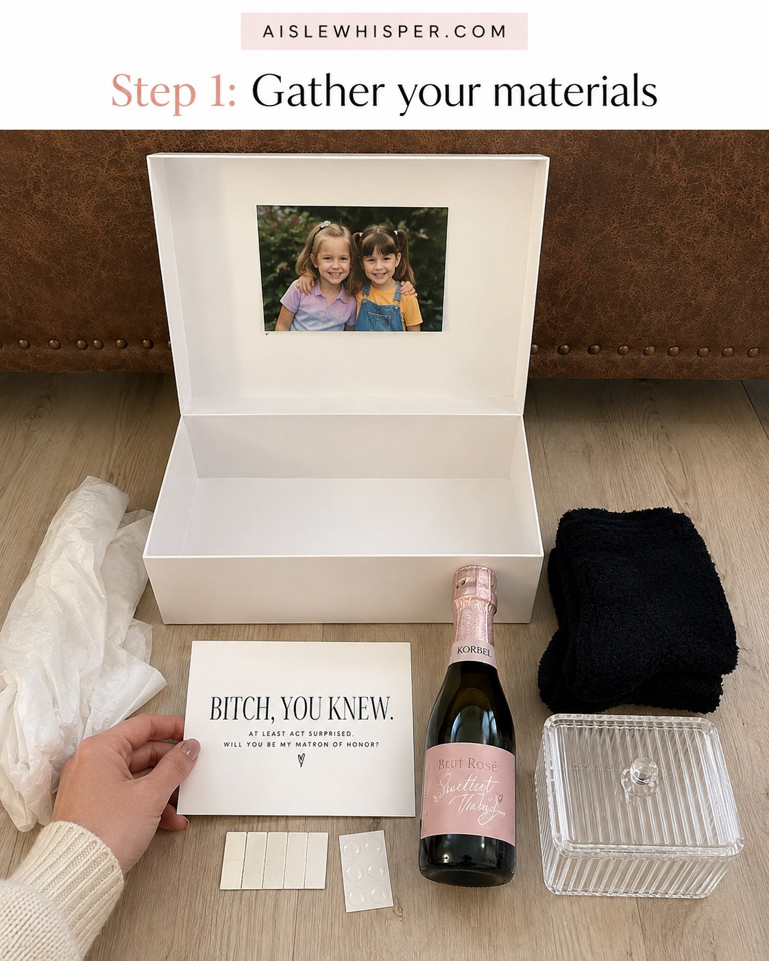 Flat-lay of matron of honor proposal box materials including tissue, socks, and a mini rosé bottle