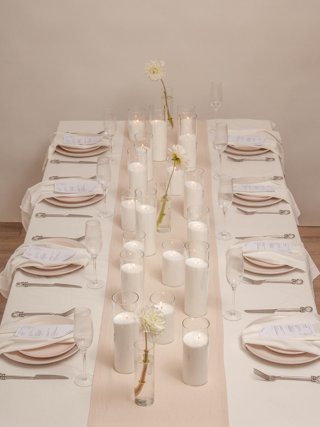 Minimalist wedding reception with white candles