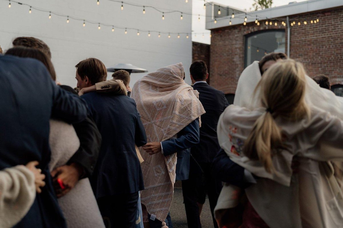 Wedding guests using blankets outdoors