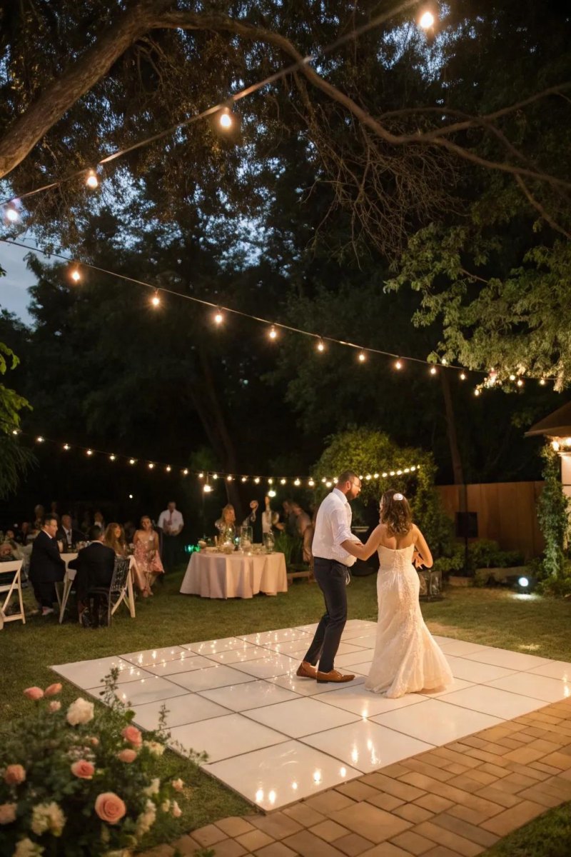 Night backyard wedding dance floor with lights