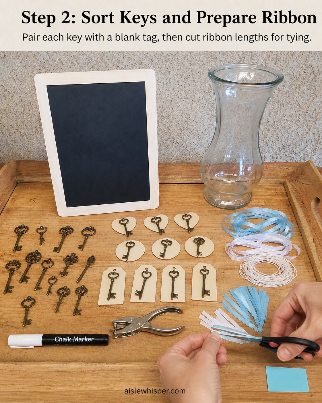 Hands pairing vintage skeleton keys with wooden tags while cutting ribbon lengths on a wooden tray