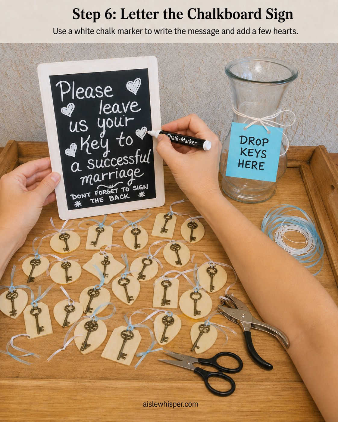 Hand-lettering a chalkboard sign in white chalk marker asking guests to leave their key to marriage