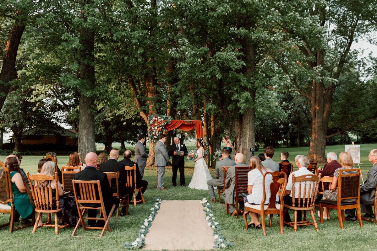 Wedding ceremony beneath backyard trees
