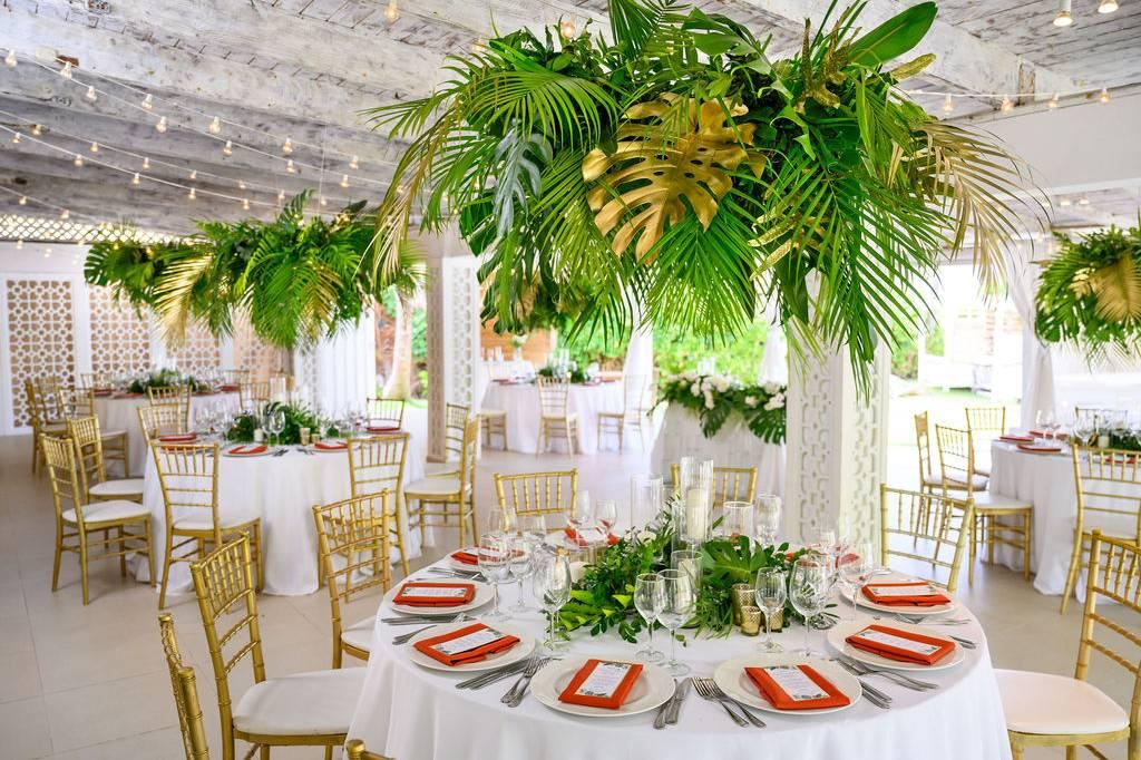 Tropical wedding reception with palm decor